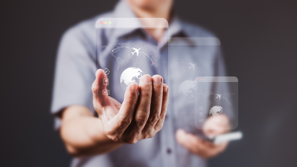 Businessman,Holding,Transparent,Virtual,Screens,With,Travel,And,Flight,Icons,
